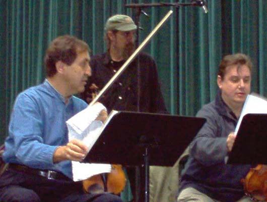 Members of The Chilingirian String Quartet discuss the Tavener commission, while a sound technician hovers, 10/23/03.