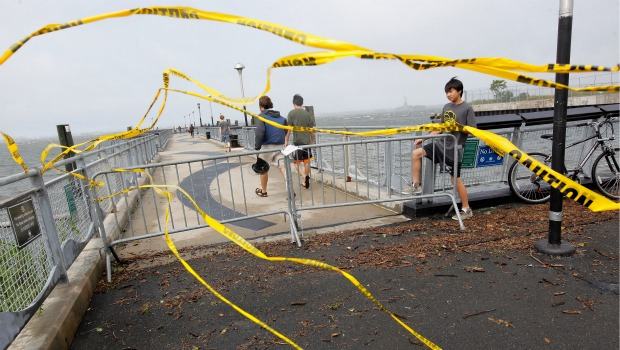 Residents slip past a barricade to enter Valentino Pier in Red Hook Brooklyn as the skies clear in the aftermath of Hurricane Irene on August 28, 2011 in New York City. Residents slip past a barricade to enter Valentino Pier in Red Hook Brooklyn as the skies clear in the aftermath of Hurricane Irene on August 28, 2011 in New York City.