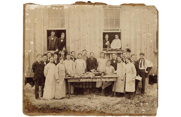“Here lies ‘McGinty’ ” is written on the negative along the side of the dissecting table. The leg of another cadaver is perched on the windowsill to the right with a hat hanging from the foot. “Here lies ‘McGinty’ ” is written on the negative along the side of the dissecting table. The leg of another cadaver is perched on the windowsill to the right with a hat hanging from the foot.