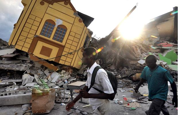 Local residents wander amidst the ruins of their hometown hours after the earthquake that hit Port-au-Prince. Local residents wander amidst the ruins of their hometown hours after the earthquake that hit Port-au-Prince.