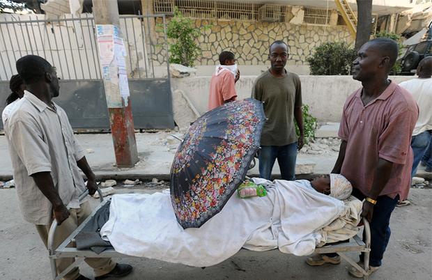 Two men carry an injured relative in Port-au-Prince, on January 14, 2010, following the devastating earthquake that rocked Haiti on January 12. Two men carry an injured relative in Port-au-Prince, on January 14, 2010, following the devastating earthquake that rocked Haiti on January 12.