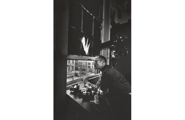 W. Eugene Smith at 4th floor window of 821 Sixth Avenue (ca. 1957). W. Eugene Smith at 4th floor window of 821 Sixth Avenue (ca. 1957).