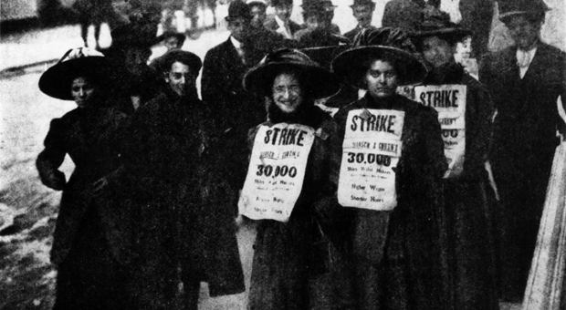 During the first days of the shirtwaist strike, men and women carry signs that read “Strike… 30,000 Shirt Waist Makers… Higher Wages and Shorter Hours.” Demands for shorter hours, better pay, and clos