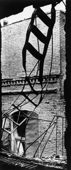 The flimsy fire escape ladder descended close to the building forcing those fleeing to struggle through flames and past warped iron window shutters stuck open across their path. Sections of ladder whi