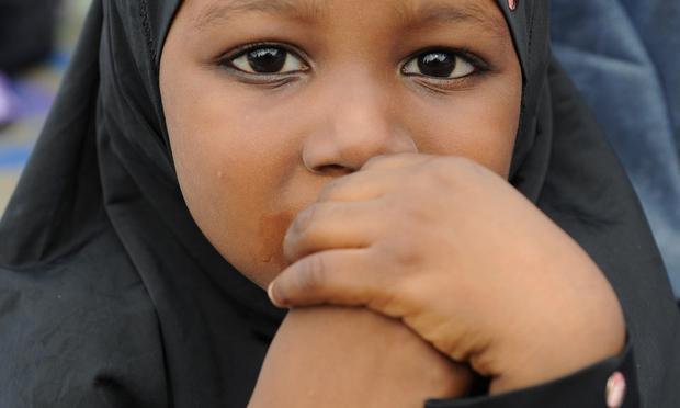 A young girl prays on the first day of Eid al-Fitr at Obalende praying ground in Lagos, Nigeria on August 19, 2012.