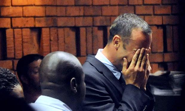 South Africa's Olympic sprinter Oscar Pistorius hides his face in his hands in the court room during his hearing on charge of murdering his model girlfriend Reeva Steenkamp.