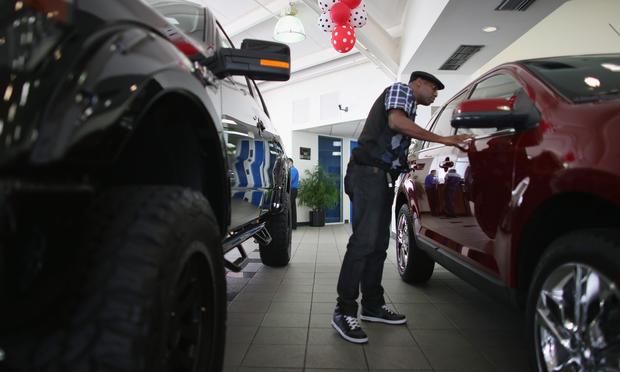 Anthony Gordon looks at a Ford vehicle on the showroom floor at a Ford AutoNation car dealership on September 4, 2013 in North Miami, Florida.