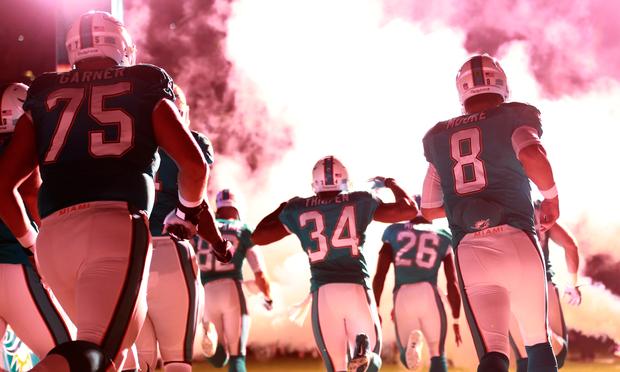 The Miami Dolphins enter the field prior turnover the game against the Cincinnati Bengals at Sun Life Stadium on October 31, 2013 in Miami Gardens, Florida.