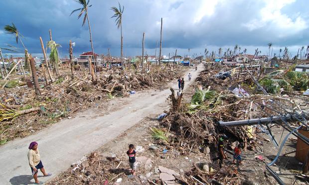 Affected residents survey the damage in Tacloban City on November 14, 2013 in Tacloban, Philippines.