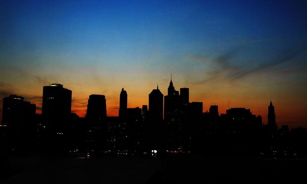 The sun sets over the Manhattan skyline August 14, 2003 during a major power outage affecting a large part of the north eastern United States and Canada.