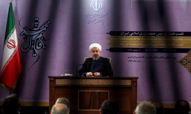 Iranian President Hassan Rouhani speaks during a press conference in Tehran on June 14, 2014. Iran may consider cooperating with the United States in fighting Sunni extremist fighters in Iraq.