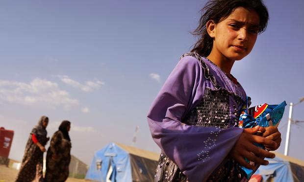 An Iraqi girl stands inside of a displacement camp for those caught-up in the fighting in and around the city of Mosul on June 28, 2014 in Khazair, Iraq. Tens of thousands have fled ISIS.