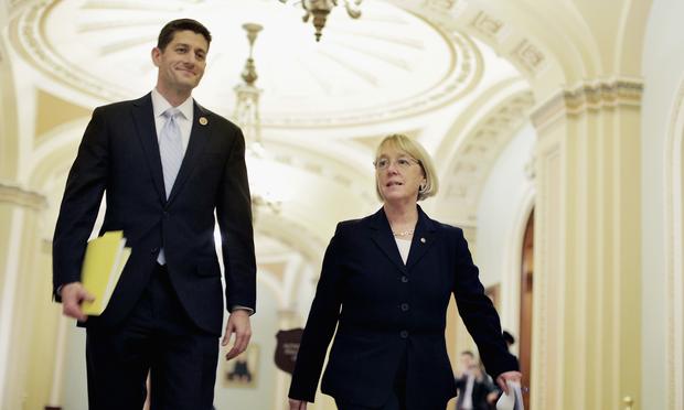 Rep. Paul Ryan (R-WI) and Sen. Patty Murray (D-WA) walk past the Senate chamber on their way to a press conference to announce a bipartisan budget deal. Dec. 10, 2013