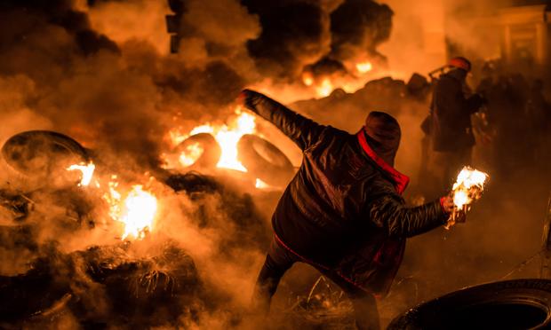 An anti-government protester throws a Molotov cocktail during clashes with police on Hrushevskoho Street near Dynamo stadium on January 25, 2014 in Kiev, Ukraine.
