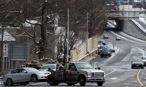 A tow truck pulls an abandoned vehicle on an exit ramp along I-75 North during the winter storm January 29, 2014 in Atlanta, Georgia