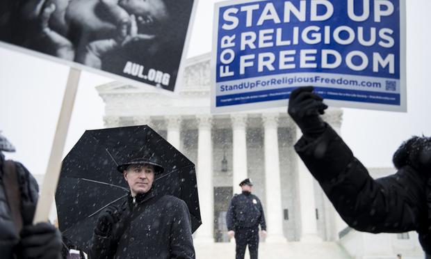 People who support Hobby Lobby's choice to withhold contraceptive healthcare coverage from their employees rally outside the US Supreme Court March 25, 2014 in Washington, DC.