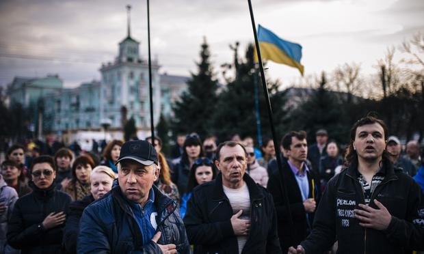 People sing the Ukrainian national anthem during a pro-Ukraine rally on April 15, 2014.