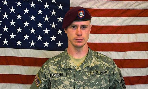 In this undated image provided by the U.S. Army, Sgt. Bowe Bergdahl poses in front of an American flag.