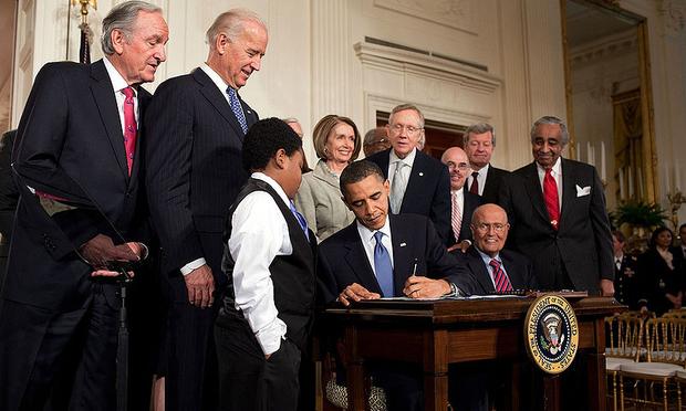 Barack Obama signing the Patient Protection and Affordable Care Act at the White House. March 23, 2010