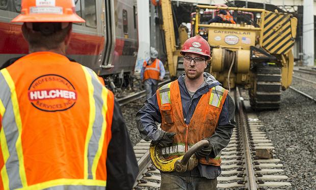 Metro-North workers repairing damage from a derailment on the New Haven Line.