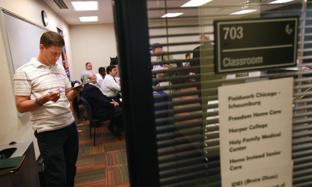 Steve Estey searches for job opportunities at a veteran's job fair ...