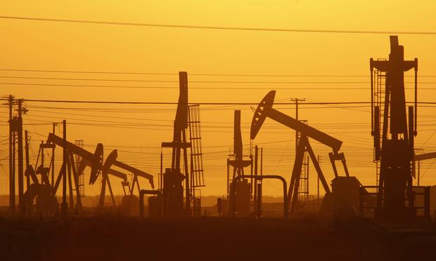 Pump jacks at dawn in an oil field over the Monterey Shale formation, where gas and oil extraction using hydraulic fracturing is on the verge of a boom on March 24, 2014, near Lost Hills, CA fracking hydraulic fracturing
