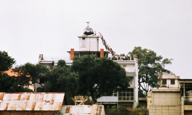 A CIA employee helps Vietnamese evacuees onto an Air America helicopter from the top of 22 Gia Long Street, a half mile from the U.S. Embassy. April 29, 1975 A CIA employee helps Vietnamese evacuees onto an Air America helicopter from the top of 22 Gia Long Street, a half mile from the U.S. Embassy. April 29, 1975