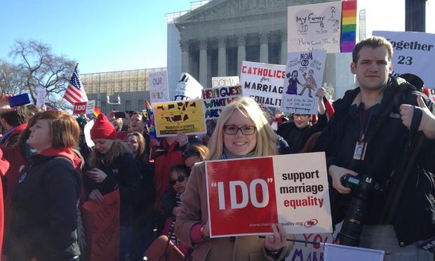 A gay marriage supporter in front of the Supreme Court during DOMA oral arguments.