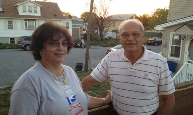 Gale and Santo Lisa on their raised back deck, where Sandy's floodwaters reached. Over Santo's shoulder, across the street, is the lot that once held the house of Diane and Ella Norris.