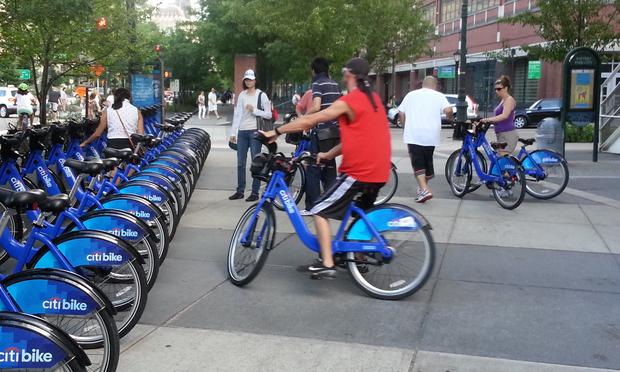 Citi Bike riders wait to return bikes at a full docking station. Chambers Street and the Hudson River bike path, June 2013