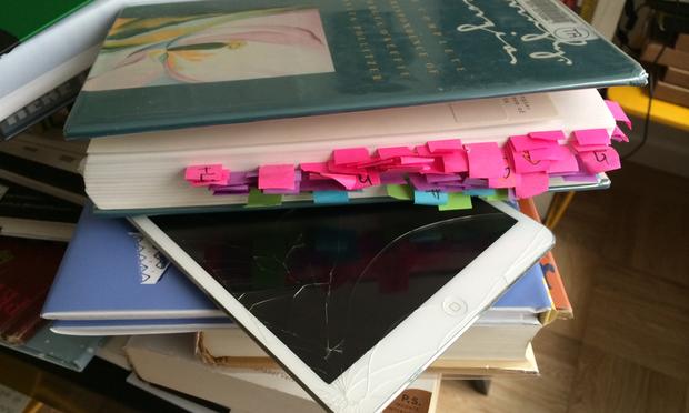 When Maria Popova, editor of Brainpickings.org, can't read a book on the iPad, she uses an elaborate system of sticky tabs and a hand written index. This is her desk. (Manoush Zomorodi/WNYC) 