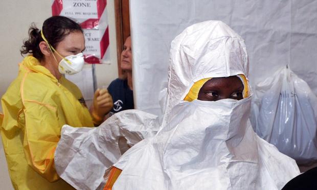 A picture taken on July 24, 2014 shows staff of the Christian charity Samaritan's Purse putting on protective gear in the ELWA hospital in the Liberian capital Monrovia.
