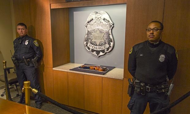 Two police officers stand guard over the recovered 300-year-old 'Lipinski' Stradivarius violin. Two police officers stand guard over the recovered 300-year-old Stradivarius violin that was taken from the Milwaukee Symphony Orchestra's concertmaster in an armed robbery last week February 6, 2014