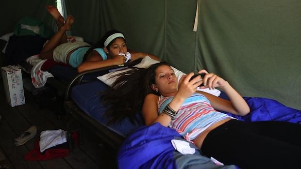 Campers were allowed to bring smartphones, tablets and other technology to Longacre Camp for the first time in the summer of 2013. Female campers uses iPhone at summer camp