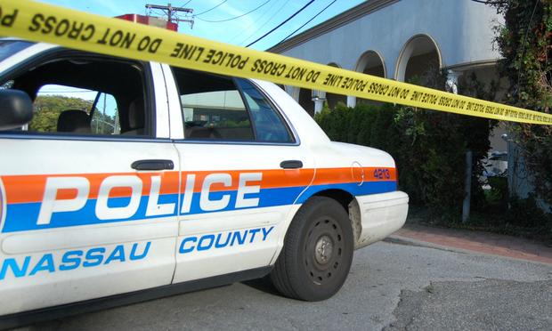 A Nassau County police car outside the shooting site in Garden City, NY
