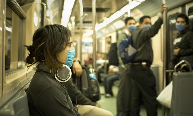 Mexico City train passengers wearing surgical masks