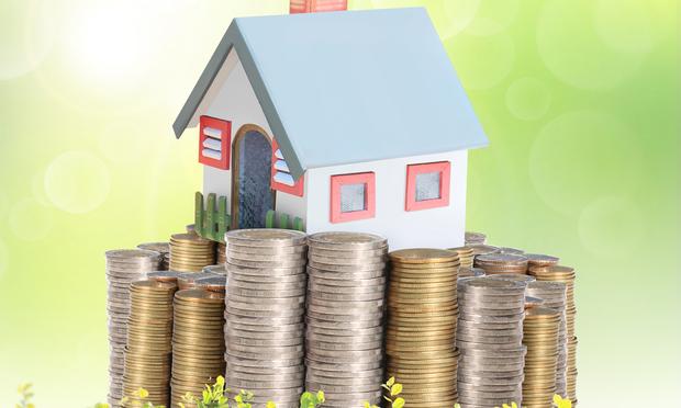 For many Americans, the home is a family's single most valuable and viable economic asset. Mortgage concept by money house from coins