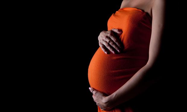 A woman late in her pregnancy.
