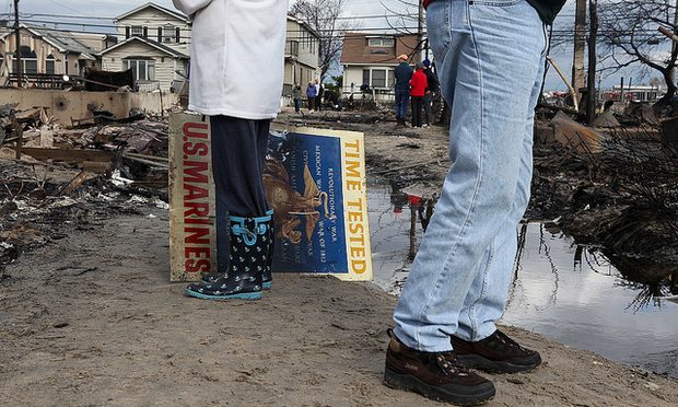 Residents recovering a lost sign at Breezy Point, Queens after Hurricane Sandy.