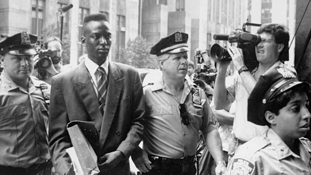 Defendant Yusef Salaam walks into courthouse flanked by police officers in Ken Burns, Sarah Burns and David McMahon’s 'The Central Park Five.'.