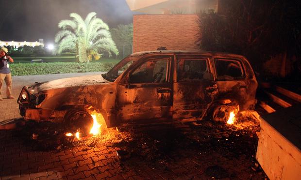 A vehicle sits smoldering in flames after being set on fire inside the American consulate compound in Benghazi late on September 11, 2012.