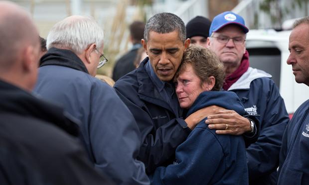 President Obama hugs Donna Vanzant, the owner of North Point Marina, as he tours damage from Hurricane Sandy in Brigantine, New Jersey.