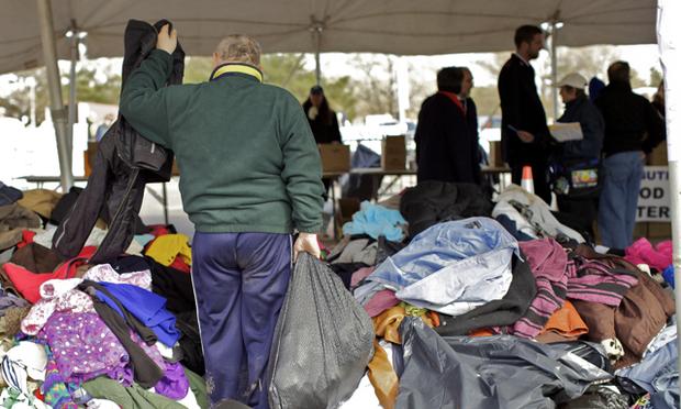 A man sorts through clothes at the Midland Beach FEMA staging area in Staten Island Monday. A man sorts through clothes at the Midland Beach FEMA staging area in Staten Island Monday.