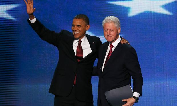 President Barack Obama joins former President Bill Clinton on stage after Clinton's speech at the Democratic National Convention.