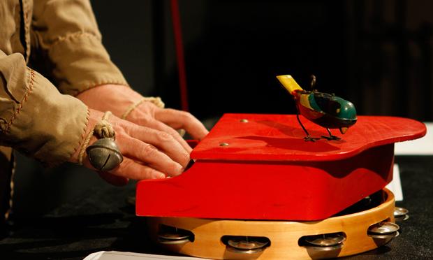Stephin Merritt plays a toy piano, on top of a tambourine, with a mechanical toy bird. Stephin Merritt plays a toy piano, on top of a tambourine, with a mechanical toy bird.