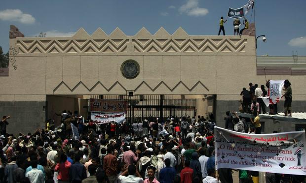 Yemeni protesters try to break through the gate of the US embassy in Sanaa during a protest over a film mocking Islam.