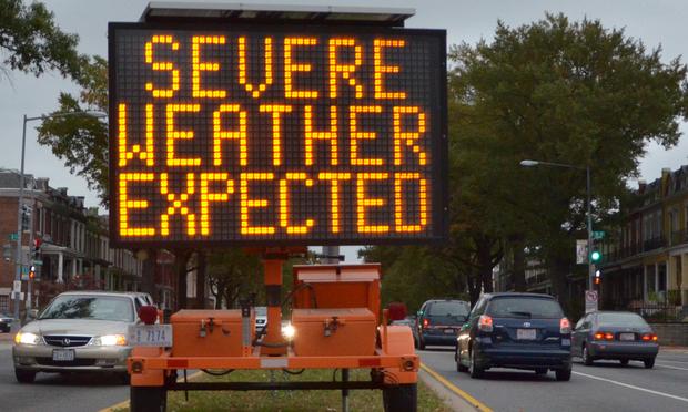 A road sign warns drivers of weather conditions in downtown Washington, DC October 28, 2012 ahead of Hurricane Sandy's landfall.
