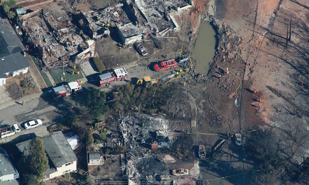 Sept 12: A section of pipe (lower right) is seen near a massive crater at the scene of a gas main explosion on Sept 9 in San Bruno, California. 38 homes were destroyed and 4 people killed.