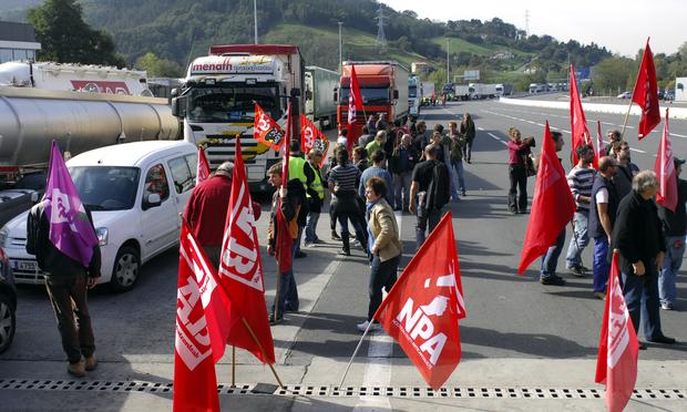 Members of French unions Sud-Solidaires, NPA, Lab, block the A64 highway between France and Spain, on October 22, 2010 in Biriatou, to protest against French government pensions reforms.