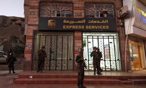 Yemeni security are seen outside a branch of the US package delivery firm UPS in Sanaa on October 30, 2010. Yemen launched a probe after explosives were found in air parcels sent to US synagogues.